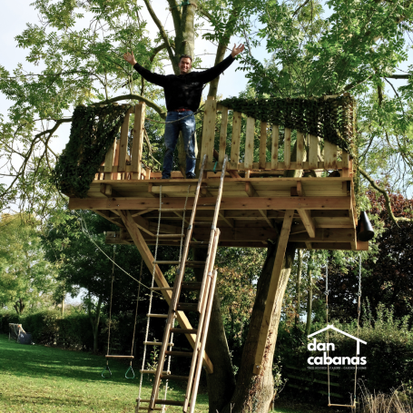 Dan standing in a tree house
